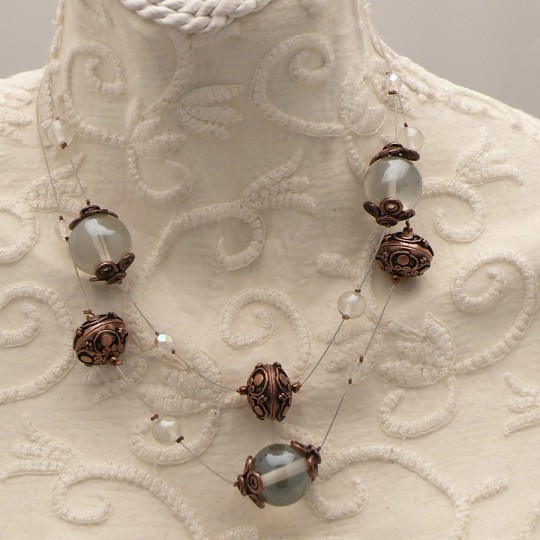 Collier fantaisie cable acier multi rangs perles cuivre transparent